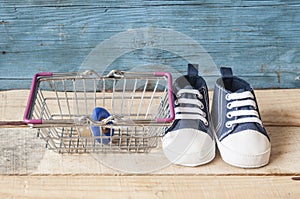 Baby shoes and shopping basket