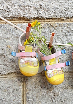 Baby shoes. Summer. Yellow flowers.