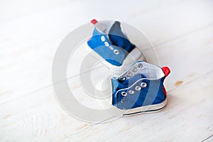 Baby shoes on wood background