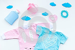 Baby shower concept. Baby`s clothes and accessories on light background top view