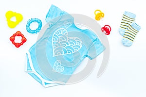 Baby shower concept. Baby`s clothes and accessories on white background top view