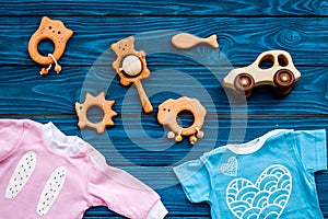 Baby shower concept. Baby`s clothes and toys on blue wooden background top view