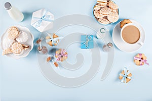 Baby shower with cookies and gifts on blue background