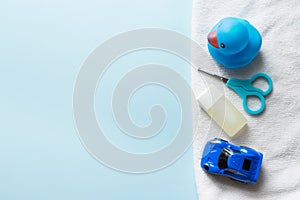Baby shower flat lay on blue background .Ñhild toys and shampoo. copy space. place for text