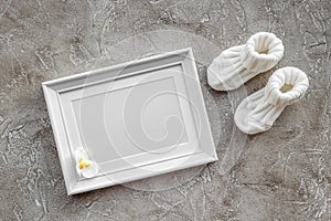 Baby shower modern design with frame on gray stone background top view mockup