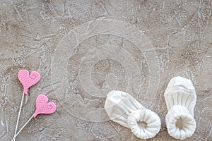 baby shower modern design with shoes on gray stone background top view mockup