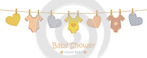Baby shower welcome greeting card for childbirth with hanging hearts and bodysuits