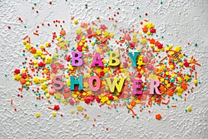 Baby shower wooden words on colorful confetti photo