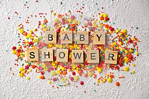 Baby shower wooden words on colorful confetti photo