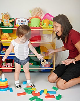 Baby sitter playing with kid photo