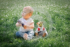 Baby sitting in green grass