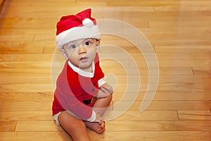 Baby sitting with Santa hat and outfit