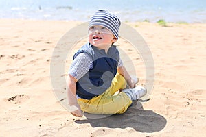 Baby sitting on shore of the lake