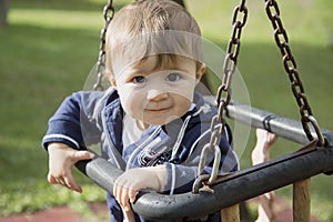 Baby sitting on swings