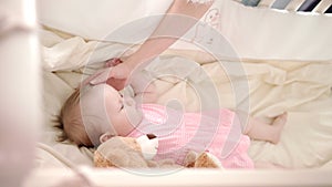 Baby sleep time. Toddler girl rest in cot. Little baby dream in crib