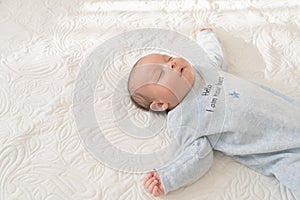 Baby Sleeping in bed white with pajama photo