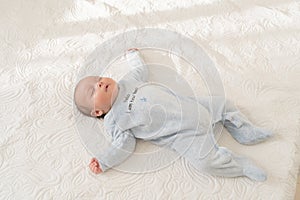Baby Sleeping in bed white with pajama photo