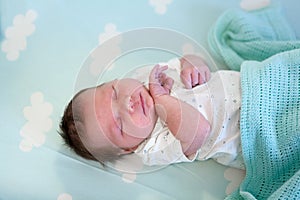 Baby sleeping in blue bed, top view