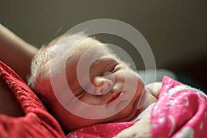 Baby sleeping on the breast of mother