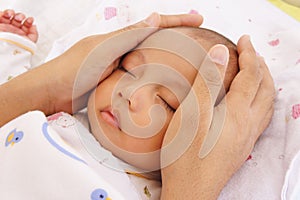 Baby sleeping and father hand