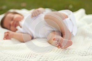 Baby sleeping on the grass