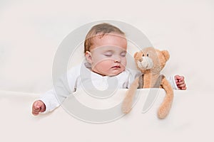 Baby sleeping with her teddy bear