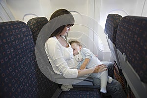 Baby Sleeping On Mother's Laps In Airplane