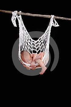 Baby sleeping in string hammock