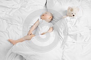 Baby sleeping with teddy bear