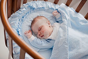 Baby sleeps with a cradle
