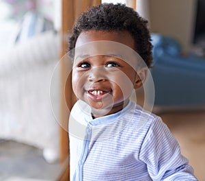 Baby, smile or teeth in childcare, health or growth in play, leisure and relaxation in living room. Happy, black boy or