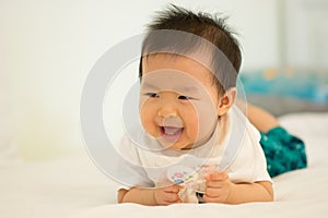 Baby smiling on the bed