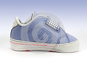 Blue baby shoe with open velcro strap, isolated, clipping path included.