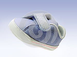 Blue baby shoe with velcro strap, isolated, clipping path included, in air. photo