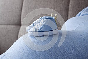 Baby sneakers in different poses / maternity period
