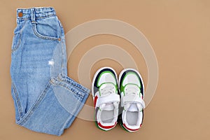 Baby sneakers and jeans pants. Set of children`s clothes and accessories for spring, autumn or summer. Fashion kids outfit,