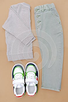 Baby sneakers,t shirt,jumper and jeans pants.Set of children& x27;s clothes and accessories for spring, autumn or summer