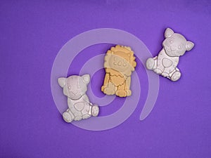 Baby soap in the forms of a tiger and a lion cub on a purple background