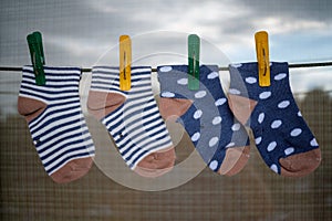 Baby socks hanging on the drying rope