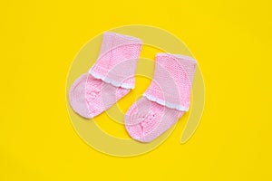 Baby socks on yellow background