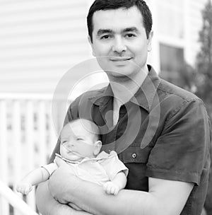 Baby son resting on Father's arm