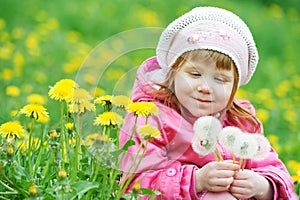 Baby with spring dandelion