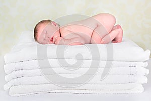 Baby on stack of towels