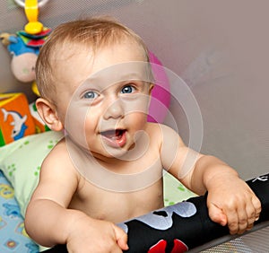 Baby standing in cot