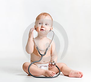 Baby with stethoscope in hands photo