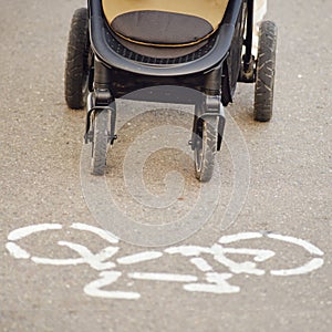 A baby stroller on a bike path in violation of traffic rules. The movemen