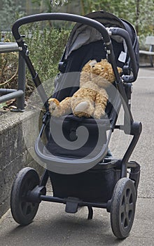 Baby stroller perambulator with teddy bear sitting in it