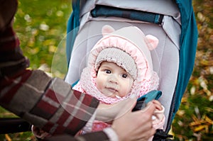 Baby in stroller on a walk in autumn park