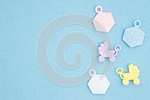 Baby strollers and abc blocks on an blue textured material background