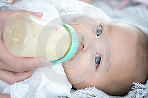 Baby sucking milk from bottle